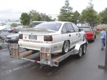 Car Trailer — Professional car transport trailers with winches, ramps, and secure wheel positioning.